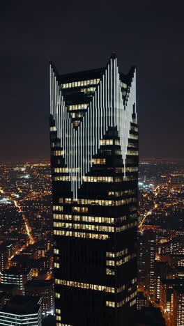 skyscraper with illuminated facade at night