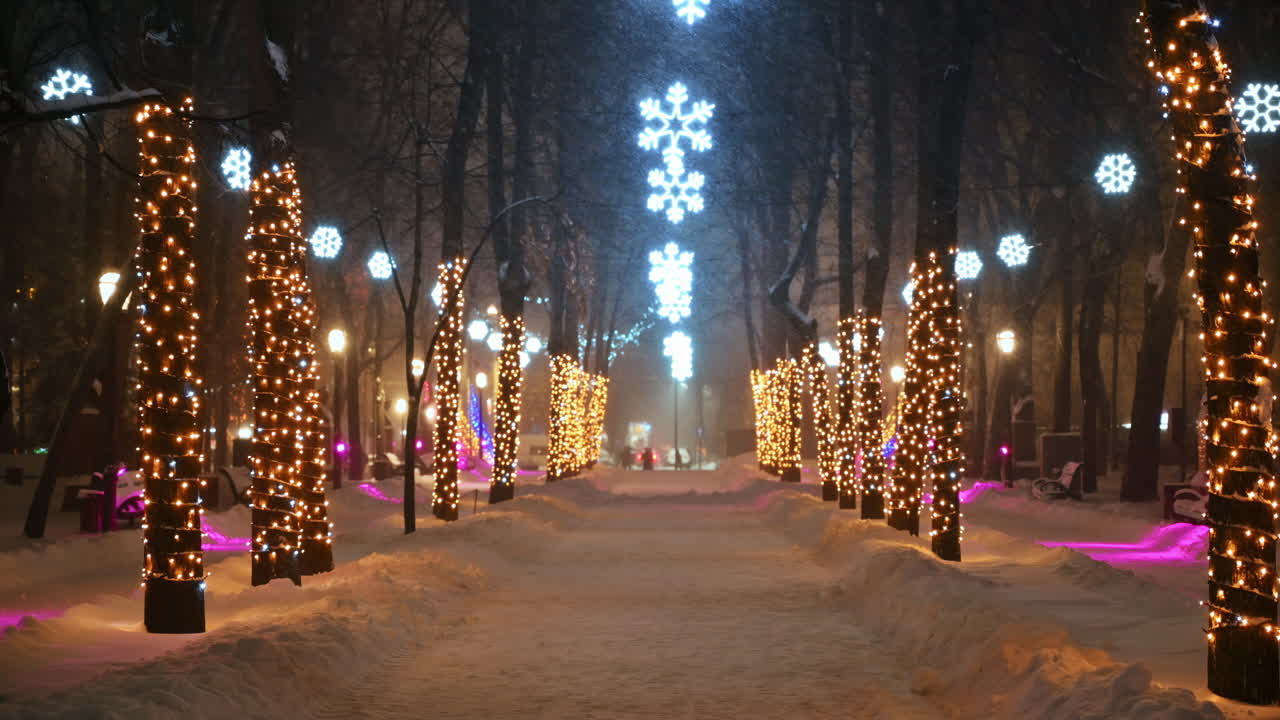 Christmas decorations in the central park during snowfall. Winter evening in Chisinau, Moldova