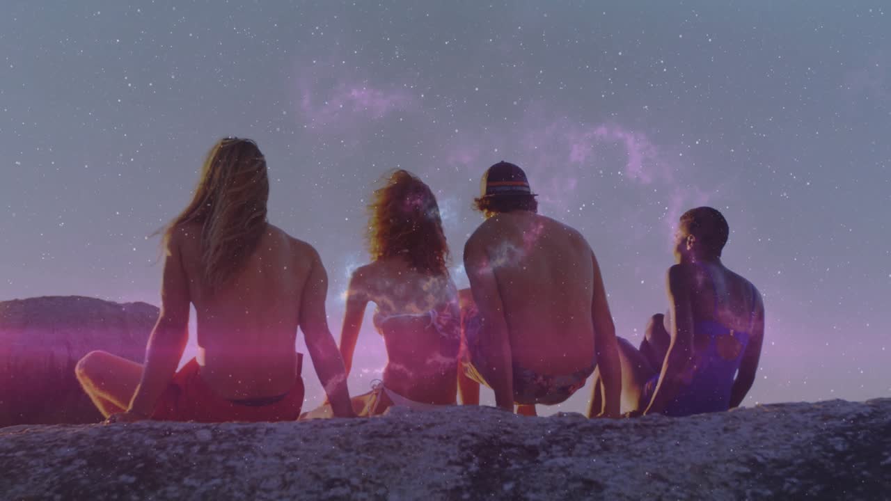 Nebula forming heart behind friends on ledge by dusk ocean friend shifting revealing companion