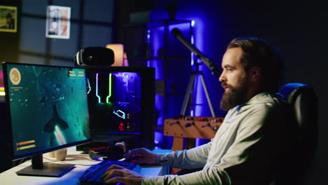 man in rgb lit studio streaming multiplayer game, chatting with audience while defeating enemies