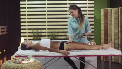 woman receiving a body scrub massage at a spa
