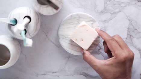 bathroom accessories and soap on marble surface