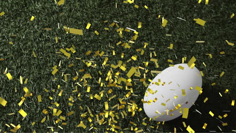 Animation-of-confetti-over-white-rugby-ball-on-grass