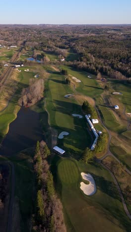 vertical view of tpc toronto at osprey valley golf course during sunset in alton, ontario, canada. aerial drone shot