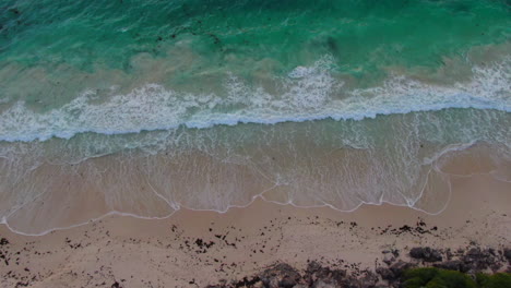 AERIAL:-Drone-shot-tilting-down-to-reveal-a-beautiful-warm-West-Australian-sunset-over-the-ocean