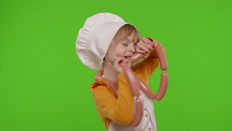 Teen-child-girl-dressed-as-cook-chef-in-apron-dancing-with-sausages,-fooling-around-on-chroma-key