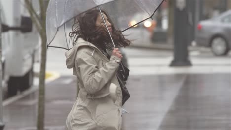 young beautiful latin woman dancing around with an umbrella in the city while listening to music