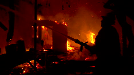 A-Firefighter-Stands-In-Silhouette-And-Fights-A-Huge-Hillside-Blaze-During-The-Thomas-Fire-In-Ventura-And-Santa-Barbara