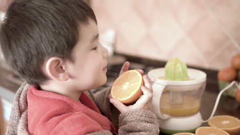 kid licking an orange and loving eat