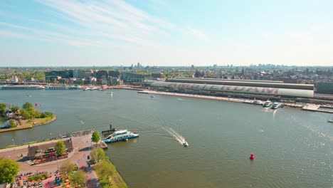 Ferry-Boats-Across-The-Ij-River-In-Amsterdam-Central-Station,-The-Netherlands