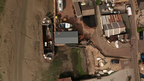 Aerial-topdown-flight-over-Old-Leigh-fishing-village-Leigh-On-Sea-showing-creeks-marshes-rooftops-of-shipyards-moored-boats-and-business-on-the-wharf-50fps-Mavic-2-Pro