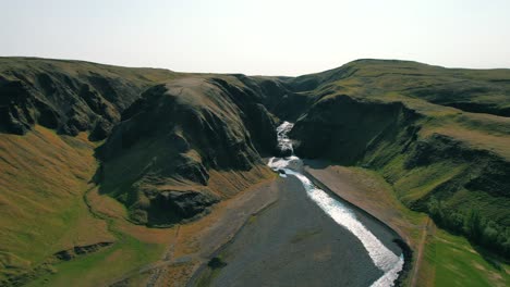 river flowing through hills of iceland in the summer