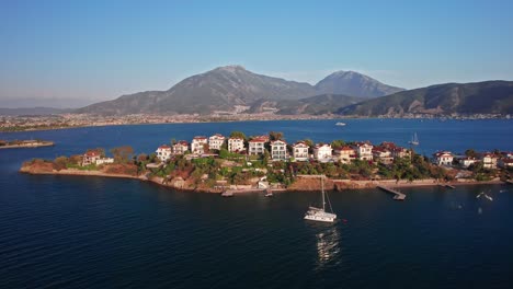 drone orbiting knight island in fethiye, turkey, at golden hour