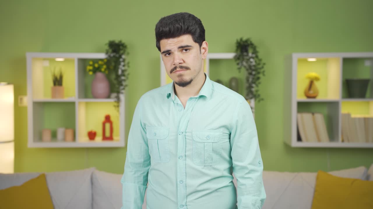 Sad depressed man is unhappy and thoughtful at home.