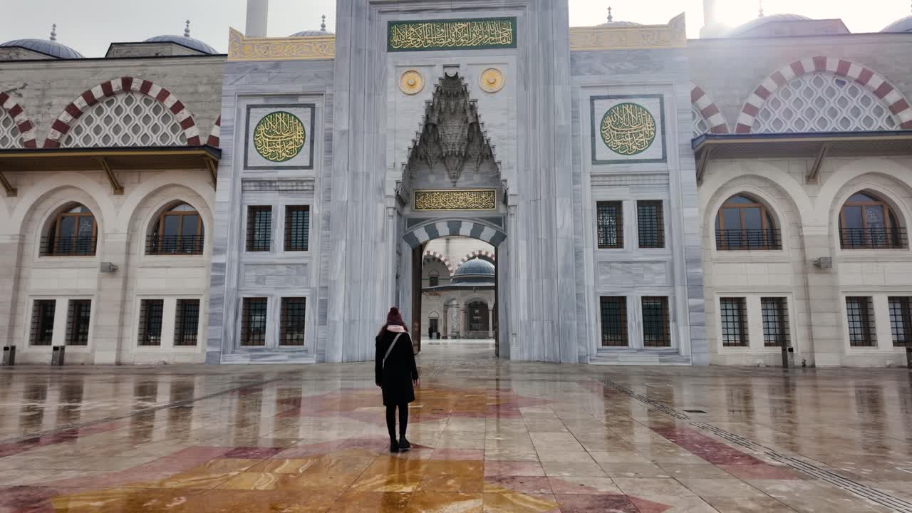 Woman entering Camlica Mosque main gate in slow motion