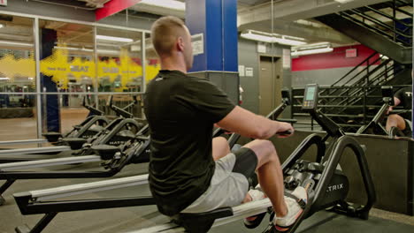 man train on sports training equipment in a fitness gym