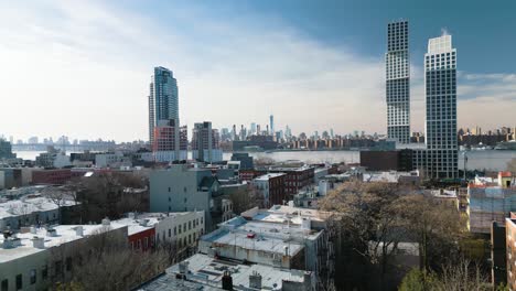 beautiful drone shot above brooklyn with manhattan skyline in background