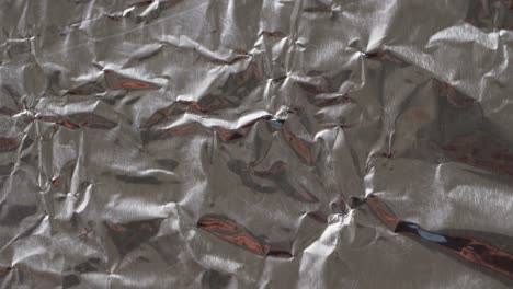 close up of gray crumpled piece of paper in slow motion