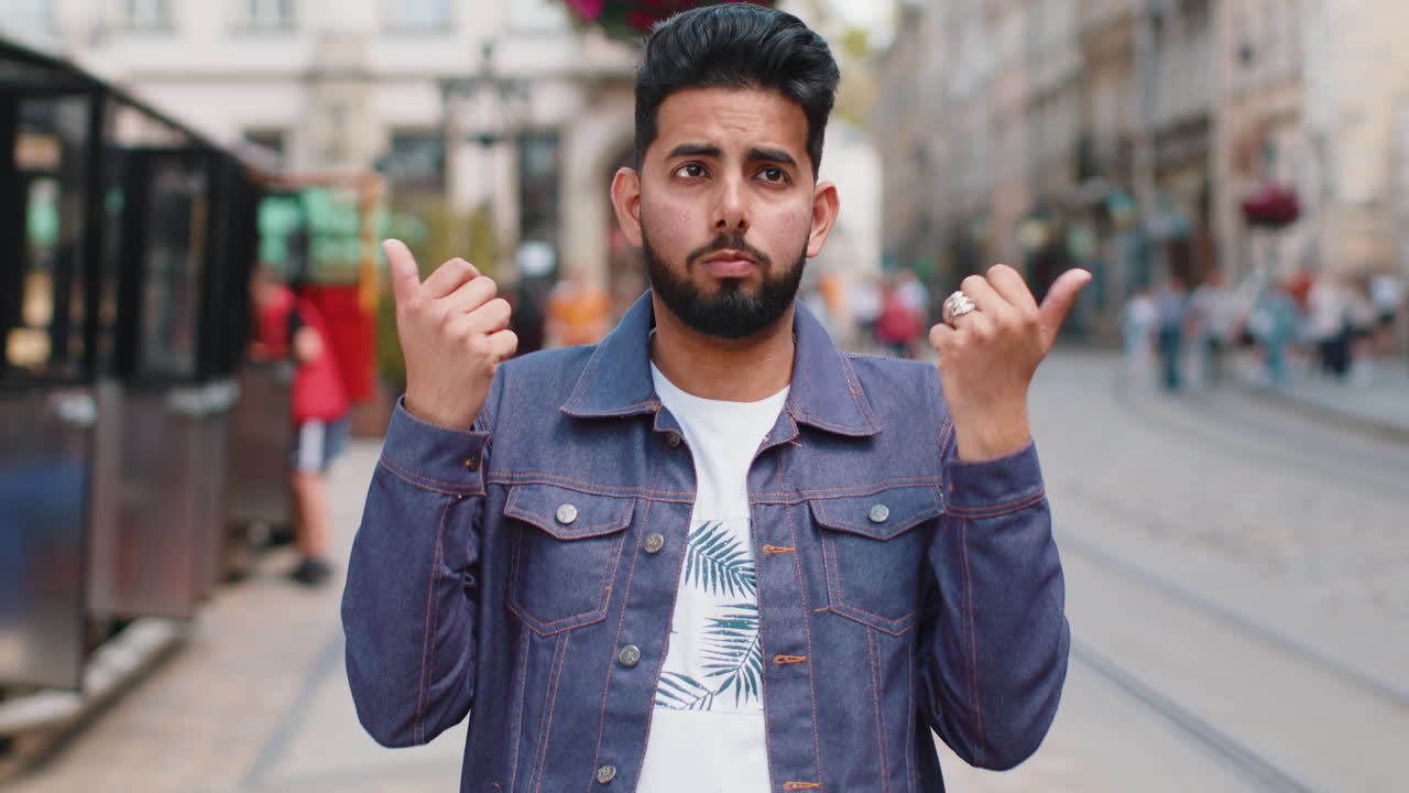 Confused man feeling embarrassed about ambiguous question having doubts no idea in city street