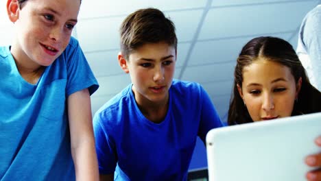 student using digital tablet in classroom