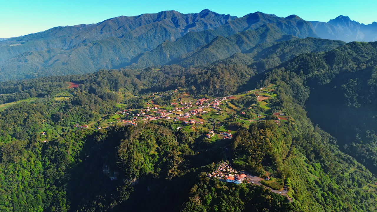 Scenic view of the beautiful village situated on the valley on mountain top. Aerial perspective on the rocky landscape of the Madeira Islands, Portugal.