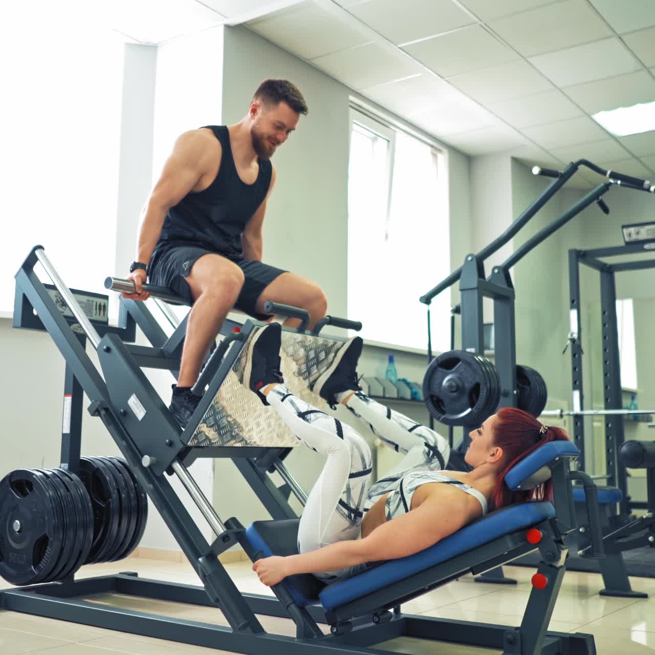 Woman weightlifter doing leg presses