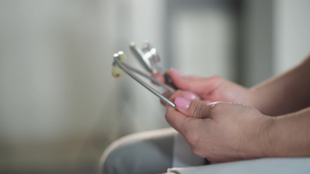 Doctor examines chest. Medical professional inspecting stethoscope features closely. Doctor carefully inspects various components of stethoscope in clinical setting for accurate diagnosis