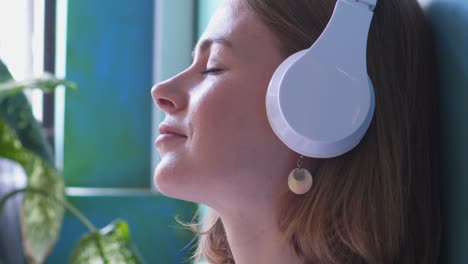 una chica encantada escuchando su canción favorita en los auriculares