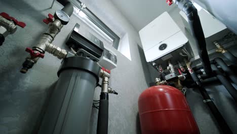 house boiler room interior with modern water heating system