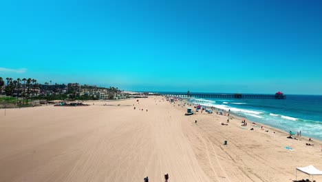 low shot flying towards the pier in huntington beach california