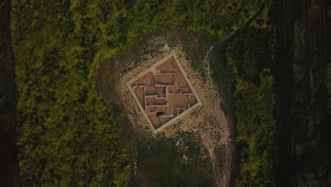 rotate birdseye view on historical ancient archaeological sites in middle of farm field agriculture land in dezful the traditional mud brick ruins of clay building plan architectural design in iran