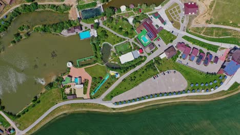 recreation area in summer. modern relaxing complex near the lake in the countryside. roofs of new hotel buildings among green nature. top view.