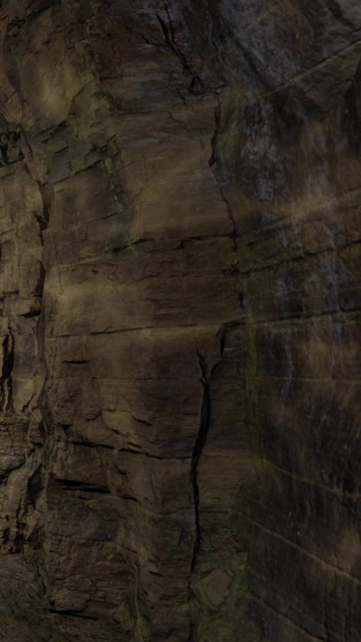 Rock formations in a cave with shadows and textures at night