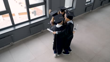 group of happy  preschool students in mortarboard and gown 11