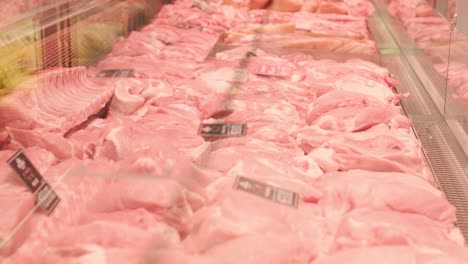 a meat shop specializing in fresh products. the scene shows neatly arranged meat on display counters, showcasing high-quality cuts in a clean and professional retail environment