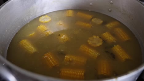 traditional colombian soup with corn cobs and chicken froth