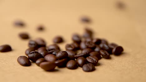 coffee beans fall on a coffee pile slow motion