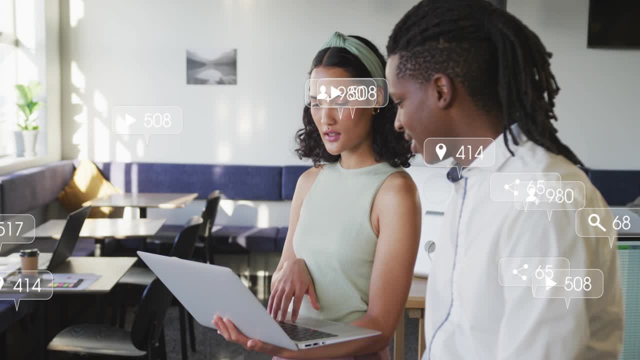Woman tapping laptop while man watching, likes and comments increasing for social metrics review