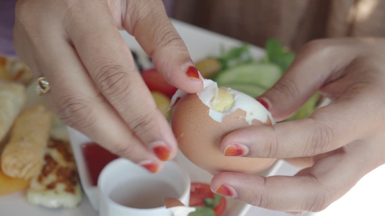 Peeling a Boiled Egg at Breakfast