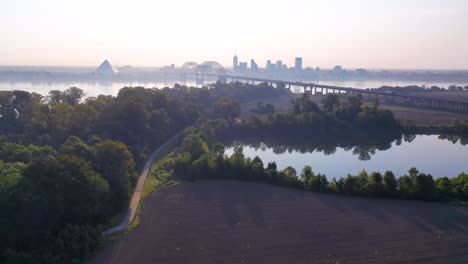 Gorgeous-aerial-approaching-Memphis-Tennessee-across-the-Mississippi-River-with-Hernando-de-Soto-Bridge-foreground