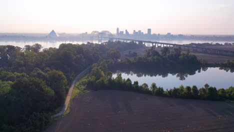 gorgeous aerial approaching memphis tennessee across the mississippi river with hernando de soto bridge foreground
