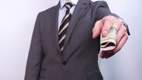 businessman shows several dollar bills