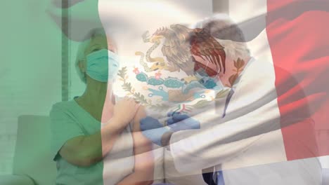 Animation-of-flag-of-mexico-waving-over-doctor-wearing-face-mask-and-vaccinating-senior-woman