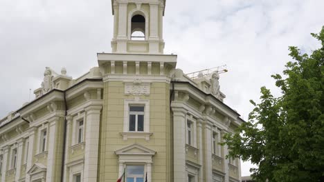 vilnius, lithuania – 29 may 2022. statue of a woman atop an old building.