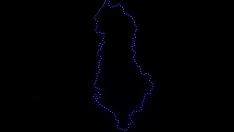 Map-of-Albania-created-by-flying-drones-on-night-sky-with-illuminated-lights,-new-technology-display