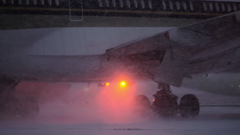 airplane taxiing to runway during the snowfall