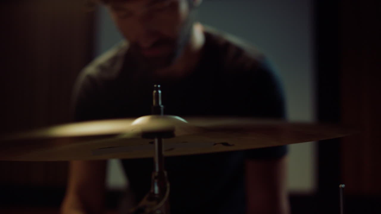 Drummer hands installing cymbal in studio. Musician twisting butterfly nut screw