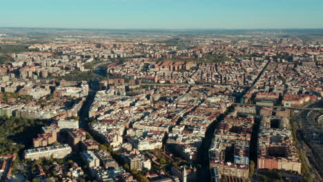 Aerial-panoramic-shot-of-vast-housing-estate-in-urban-neighbourhood.-Traffic-on-road-leading-through-city.