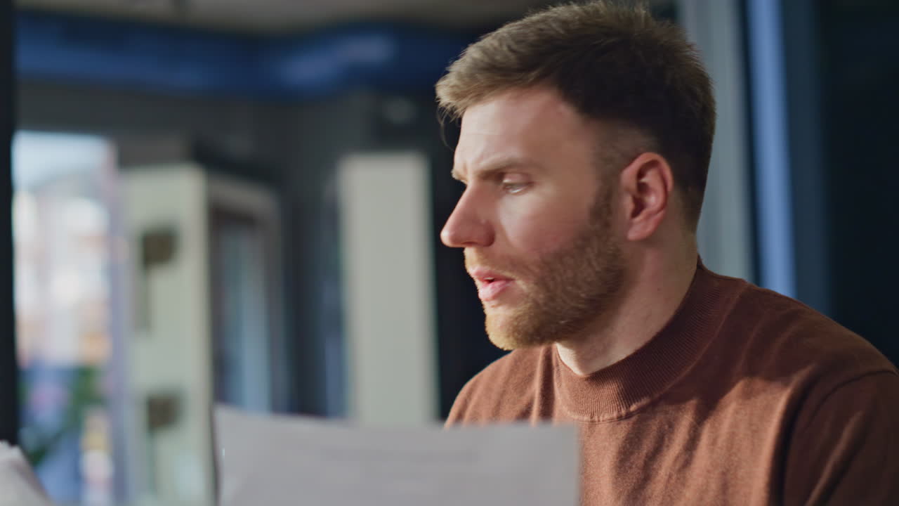 Pensive entrepreneur working documents developing project in office closeup