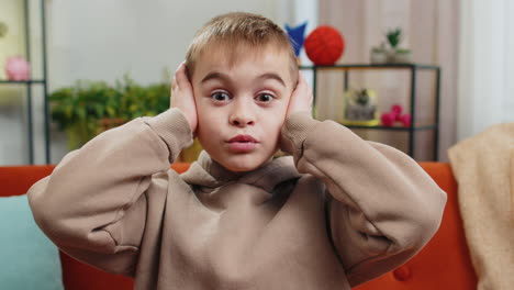 excited boy child kid surprised shocked by sudden victory good win news celebrating wow reaction